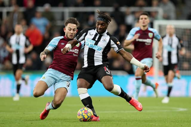 Allan Saint-Maximin of Newcastle United is tackled by Josh Brownhill of Burnley during the Premier League match between Newcastle United and Burnley at St. James Park on December 04, 2021 in Newcastle upon Tyne, England.