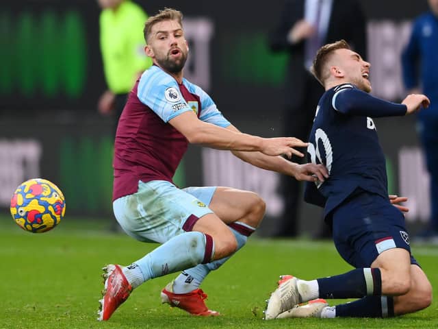 Jarrod Bowen of West Ham United is fouled by Charlie Taylor of Burnley during the Premier League match between Burnley and West Ham United at Turf Moor on December 12, 2021 in Burnley, England.
