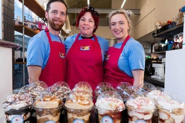 Cheryl Jackson (centre) with her partner Shaun Foxcroft and daughter in law Joanne White at the shop Cuppa Cakes Ltd in Burnley