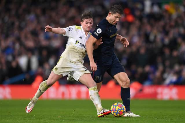 LEEDS, ENGLAND - JANUARY 02: Burnley player James Tarkowski is challenged by Leeds player Joe Gelhardt (l)  during the Premier League match between Leeds United  and  Burnley at Elland Road on January 02, 2022 in Leeds, England. (Photo by Stu Forster/Getty Images)