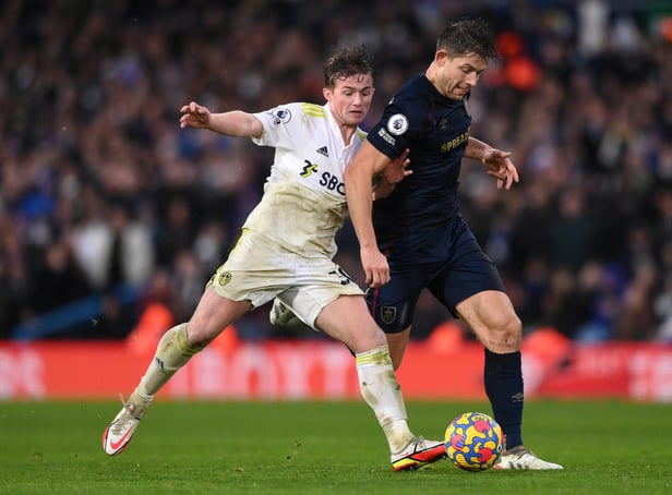 LEEDS, ENGLAND - JANUARY 02: Burnley player James Tarkowski is challenged by Leeds player Joe Gelhardt (l)  during the Premier League match between Leeds United  and  Burnley at Elland Road on January 02, 2022 in Leeds, England. (Photo by Stu Forster/Getty Images)