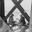 Two men working on a girder in Blackpool Tower in 1933. They seem as comfortable as if they were sat at a desk!