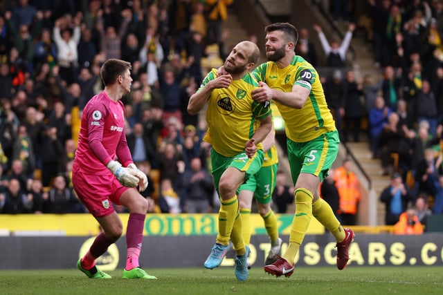 NORWICH, ENGLAND - APRIL 10: Teemu Pukki of Norwich City celebrates with team mate Grant Hanley after scoring their sides second goal during the Premier League match between Norwich City and Burnley at Carrow Road on April 10, 2022 in Norwich, England. (Photo by Paul Harding/Getty Images)