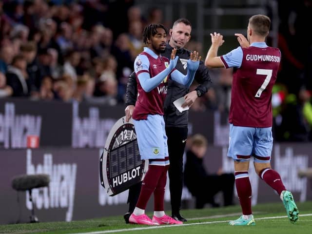 BURNLEY, ENGLAND - SEPTEMBER 23: Johann Guomundsson of Burnley interacts with Mike Tresor Ndayishimiye of Burnley after being substituted off during the Premier League match between Burnley FC and Manchester United at Turf Moor on September 23, 2023 in Burnley, England. (Photo by Lewis Storey/Getty Images)