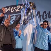 Manchester City's Spanish manager Pep Guardiola (C), Manchester City assistant coach Mikel Arteta (R) and Manchester City's Belgian defender Vincent Kompany (L) show the Premier League trophy to supporters outside the Etihad Stadium in Manchester, northern England on May 12, 2019. - Manchester City held off a titanic challenge from Liverpool to become the first side in a decade to retain the Premier League on Sunday by coming from behind to beat Brighton 4-1 on Sunday. (Photo by OLI SCARFF / AFP)        (Photo credit should read OLI SCARFF/AFP via Getty Images)