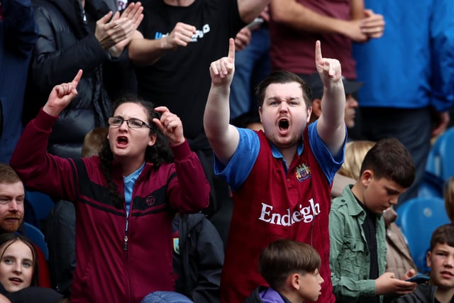 BURNLEY, ENGLAND - MAY 22: Burnley fans celebrate during the Premier League match between Burnley and Newcastle United at Turf Moor on May 22, 2022 in Burnley, England. (Photo by Jan Kruger/Getty Images)
