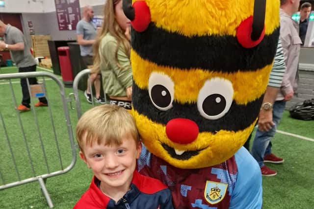 Wilbur, who is taking part in a fundraising football match, is pictured with Burnley Football Club's Bertie Bee.