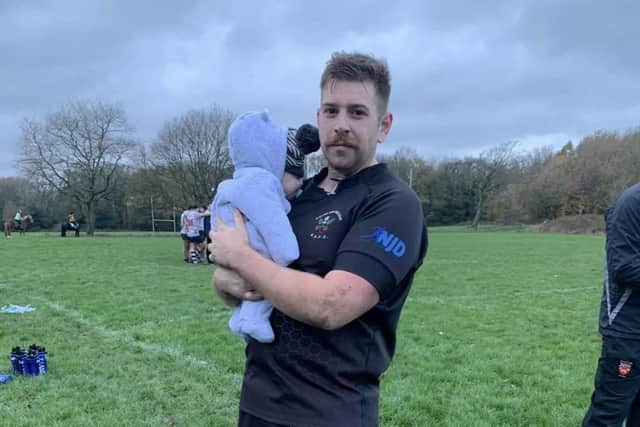 Nathan at rugby with his baby son Noah
