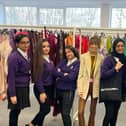 Sophie Clark (centre) who is the communications and engagement advisor at Boohoo Group with some of the students who went along to the 'pop up' prom dress shop