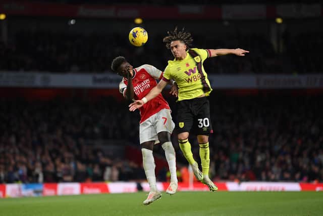 LONDON, ENGLAND - NOVEMBER 11: Bukayo Saka of Arsenal and Luca Koleosho of Burnley battle for a header during the Premier League match between Arsenal FC and Burnley FC at Emirates Stadium on November 11, 2023 in London, England. (Photo by Justin Setterfield/Getty Images)