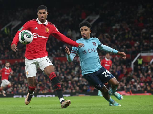 MANCHESTER, ENGLAND - DECEMBER 21: Marcus Rashford of Manchester United in action with Ian Maatsen of Burnley during the Carabao Cup Fourth Round match between Manchester United and Burnley at Old Trafford on December 21, 2022 in Manchester, England. (Photo by Matthew Peters/Manchester United via Getty Images)