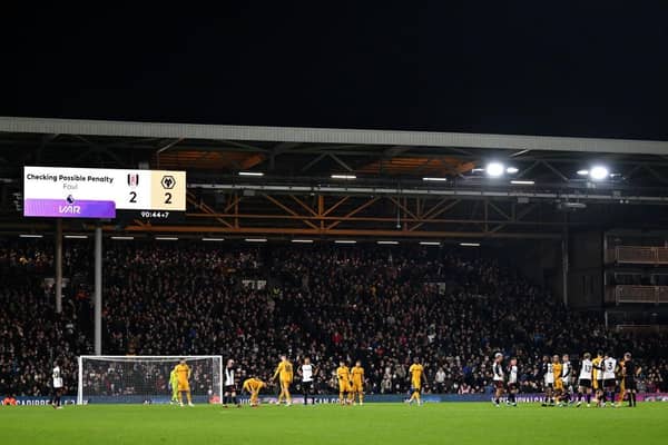 LONDON, ENGLAND - NOVEMBER 27: A general view of the inside of the stadium as The LED board shows the message "Checking Possible Penalty Foul", after a VAR Review takes place after Harry Wilson of Fulham (not pictured) is fouled by Joao Gomes of Wolverhampton Wanderers (not pictured), during the Premier League match between Fulham FC and Wolverhampton Wanderers at Craven Cottage on November 27, 2023 in London, England. (Photo by Mike Hewitt/Getty Images)