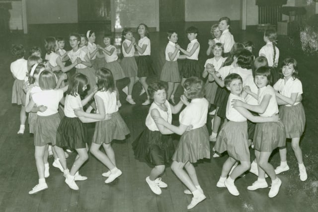 Heasandford Junior School, Burnley. Girls dancing in the school hall. (1970). Credit: Lancashire County Council