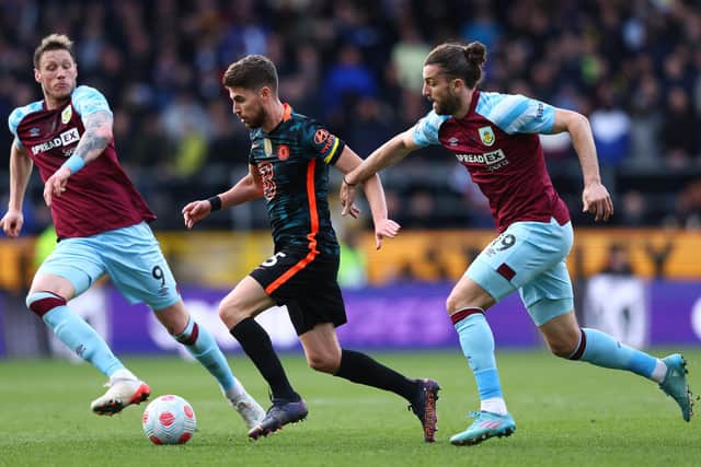 BURNLEY, ENGLAND - MARCH 05:  Jorginho of Chelsea is challenged by Wout Weghorst and Jay Rodriguez of Burnley during the Premier League match between Burnley and Chelsea at Turf Moor on March 05, 2022 in Burnley, England.
