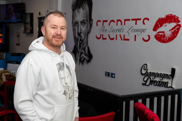 David Fowler, the manager of Secrets Lounge in Burnley, stood next to the David Bowie mural.