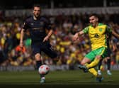 NORWICH, ENGLAND - APRIL 10: Kenny McLean of Norwich City shoots whilst under pressure from Jay Rodriguez of Burnley during the Premier League match between Norwich City and Burnley at Carrow Road on April 10, 2022 in Norwich, England. (Photo by Paul Harding/Getty Images)