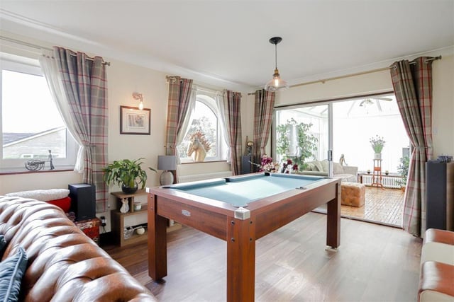 Pool table leading into conservatory
