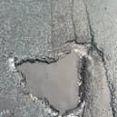 The pothole that County Cllr John Fillis was told had been filled in after he reported it - but which was still blighting the road days later