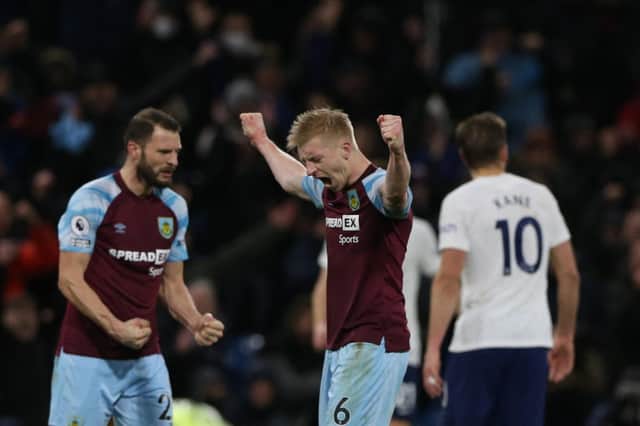 Burnley's English defender Ben Mee (C) celebrates at the end of the English Premier League football match between Burnley and Tottenham at Turf Moor in Burnley, north west England on February 23, 2022. - RESTRICTED TO EDITORIAL USE. No use with unauthorized audio, video, data, fixture lists, club/league logos or 'live' services. Online in-match use limited to 120 images. An additional 40 images may be used in extra time. No video emulation. Social media in-match use limited to 120 images. An additional 40 images may be used in extra time. No use in betting publications, games or single club/league/player publications. (Photo by NIGEL RODDIS / AFP) / RESTRICTED TO EDITORIAL USE. No use with unauthorized audio, video, data, fixture lists, club/league logos or 'live' services. Online in-match use limited to 120 images. An additional 40 images may be used in extra time. No video emulation. Social media in-match use limited to 120 images. An additional 40 images may be used in extra time. No use in betting publications, games or single club/league/player publications. / RESTRICTED TO EDITORIAL USE. No use with unauthorized audio, video, data, fixture lists, club/league logos or 'live' services. Online in-match use limited to 120 images. An additional 40 images may be used in extra time. No video emulation. Social media in-match use limited to 120 images. An additional 40 images may be used in extra time. No use in betting publications, games or single club/league/player publications. (Photo by NIGEL RODDIS/AFP via Getty Images)
