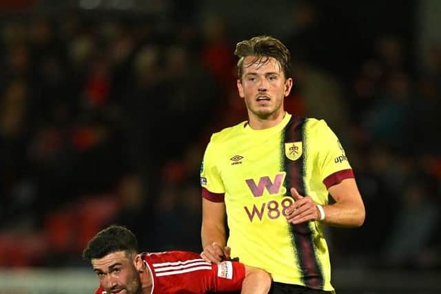 SALFORD, ENGLAND - SEPTEMBER 26: Stevie Mallan of Salford City challenges for the ball with Sander Berge of Burnley during the Carabao Cup Third Round match between Salford City and Burnley at Peninsula Stadium on September 26, 2023 in Salford, England. (Photo by Michael Regan/Getty Images)