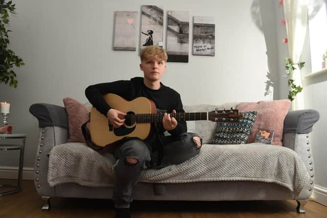 Musician Charlie Whittam, 16, pictured  practising at home   hoto: Neil Cross