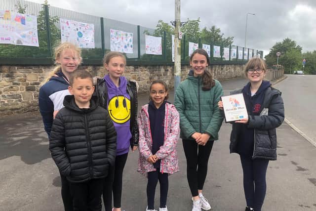 Some of the pupils who designed posters on sustainable travel which went on display at Rosegrove railway station in Burnley