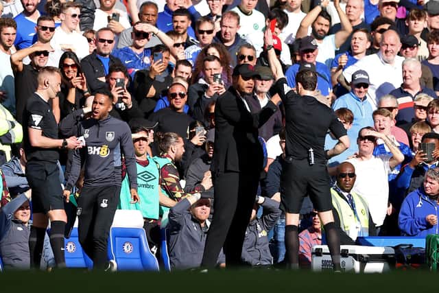 LONDON, ENGLAND - MARCH 30: Vincent Kompany, Manager of Burnley, is shown a red card by Referee Darren England during the Premier League match between Chelsea FC and Burnley FC at Stamford Bridge on March 30, 2024 in London, England. (Photo by Richard Pelham/Getty Images)