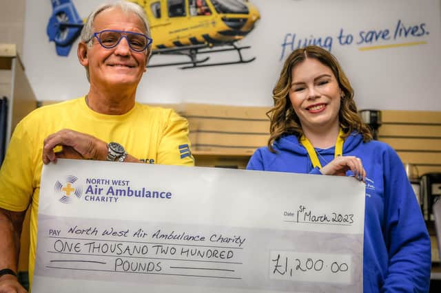 Ivor hands over a cheque for the cash he raised doing  a wing walk to a representative of the North West Air Ambulance