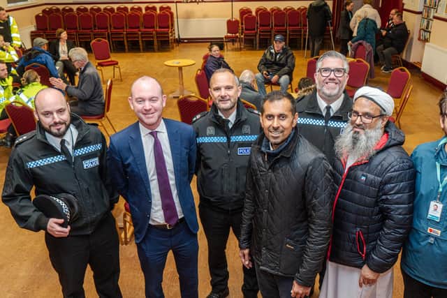 Photo shows representatives from Burnley Council, Lancashire Police, community leaders and other partners with local residents at St Cuthbert's Church