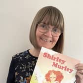 Su Murley with her new book