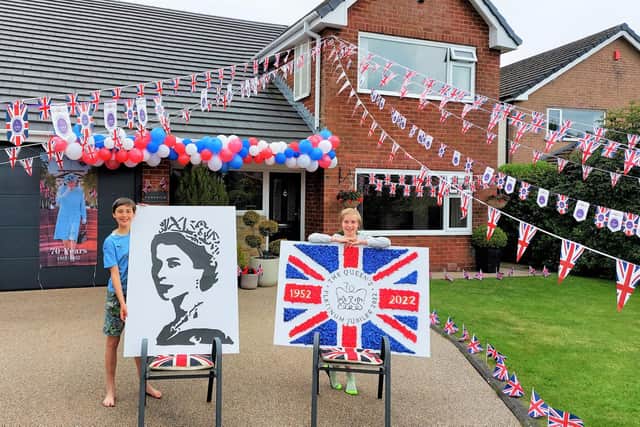 Ethan and Lucas Holden outside 'Best Dressed House' in Waddington, decorated to mark the Queen's Platinum Jubilee