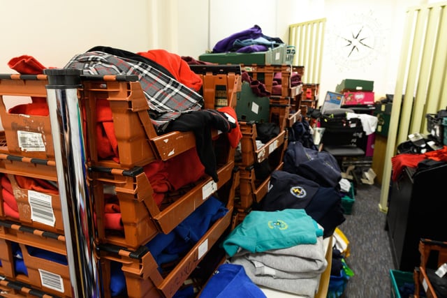 Donated school uniforms that are waiting for space to be put on display inside the store.