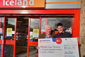 Ian Ponton, who has raised over £6,000 for Rosemere Cancer by dressing as Santa at a range of different stores in Burnley, is  pictured left  with Iceland store manager Barry Gibson.
