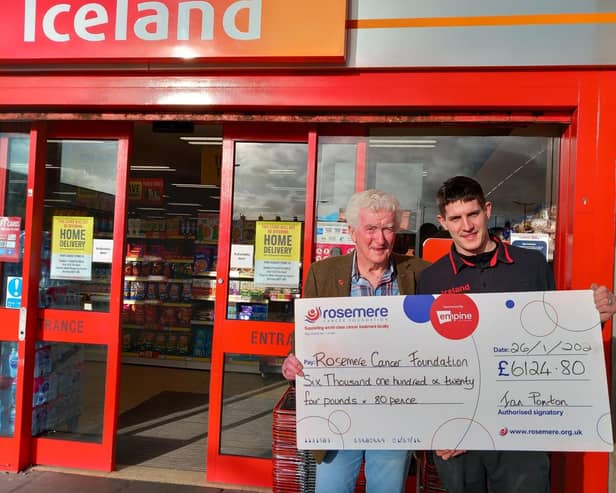Ian Ponton, who has raised over £6,000 for Rosemere Cancer by dressing as Santa at a range of different stores in Burnley, is  pictured left  with Iceland store manager Barry Gibson.
