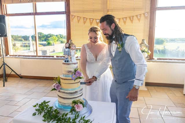 Louis and Natasha Gilbraith cut into the wedding cake made for them by baker Cheryl Jackson after the company they bought their original cake from went into liquidation weeks before their big day