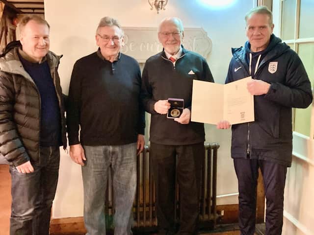 The photo shows Peter Shaw (second from right) being presented with his award by the Lancashire Football Association League Development Officer, John Tracey, watched on by League Secretary, Chris Hogan and Chairman, Phil Caine.