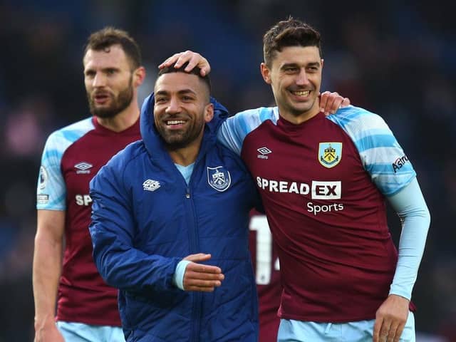 BRIGHTON, ENGLAND - FEBRUARY 19: Aaron Lennon of Burnley embraces Matthew Lowton following their sides victory in the Premier League match between Brighton & Hove Albion and Burnley at American Express Community Stadium on February 19, 2022 in Brighton, England. (Photo by Charlie Crowhurst/Getty Images)