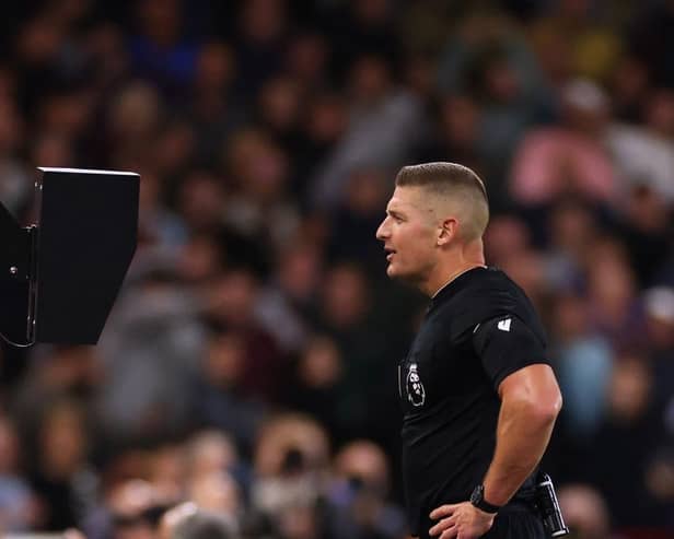 NOTTINGHAM, ENGLAND - SEPTEMBER 18:  Referee Robert Jones reviews the VAR screen during the Premier League match between Nottingham Forest and Burnley FC at City Ground on September 18, 2023 in Nottingham, United Kingdom. (Photo by Marc Atkins/Getty Images)