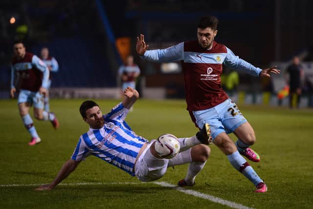 BURNLEY, ENGLAND - FEBRUARY 26:  Charlie Austin of Burnley battles with Anthony Gerrard of Huddersfield Town during the npower Championship match between Burnley and Huddersfield Town at Turf Moor on February 26, 2013 in Burnley, England.