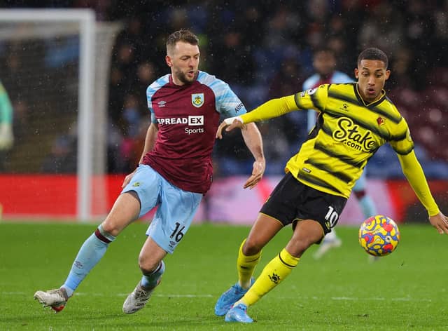 BURNLEY, ENGLAND - FEBRUARY 05: Dale Stephens of Burnley battles for possession with Joao Pedro of Watford during the Premier League match between Burnley and Watford at Turf Moor on February 05, 2022 in Burnley, England. (Photo by James Gill/Getty Images)