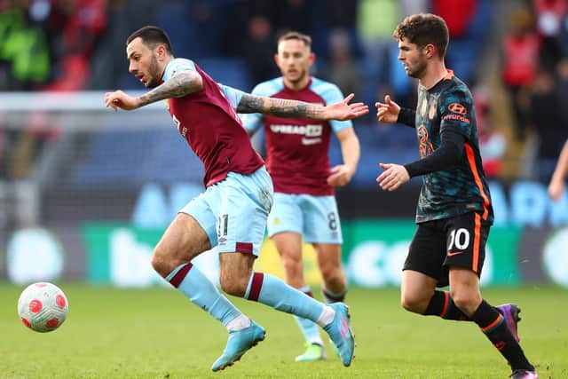 BURNLEY, ENGLAND - MARCH 05: Dwight McNeil of Burnley is challenged by Christian Pulisic of Chelsea during the Premier League match between Burnley and Chelsea at Turf Moor on March 05, 2022 in Burnley, England.