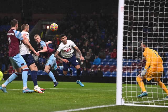 BURNLEY, ENGLAND - FEBRUARY 23: Burnley player Ben Mee beats Tottenham player Cristian Romero to head the winning goal  during the Premier League match between Burnley and Tottenham Hotspur at Turf Moor on February 23, 2022 in Burnley, England.  (Photo by Stu Forster/Getty Images)