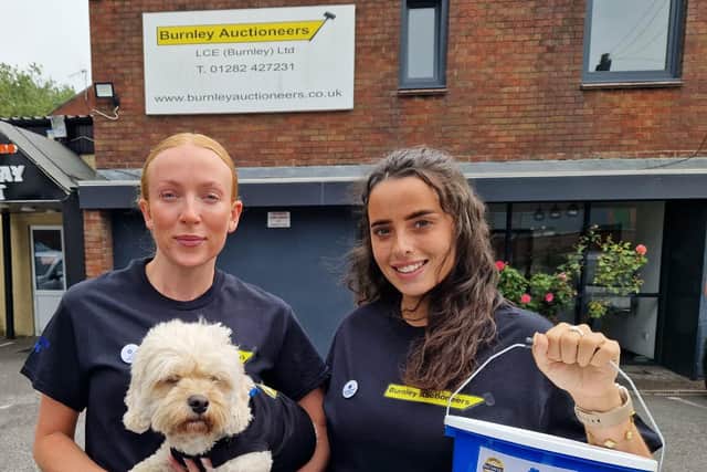 Lily Bradshaw (left) a director at Burnley Auctioneers and admin assistant Amelia Tahir, are all set for the charity pub walk they have organised for this weekend to raise cash for the Alzheimer's Society. Even Honey the dog will be joining them on the walk