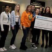 Sharon Hacking and her daughter Jo from Inbetweenears presenting a cheque to students and staff from the School of Pharmacy and Biomedical Sciences at UCLan.