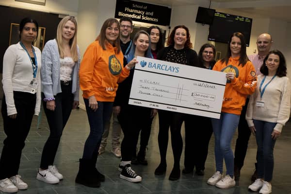 Sharon Hacking and her daughter Jo from Inbetweenears presenting a cheque to students and staff from the School of Pharmacy and Biomedical Sciences at UCLan.