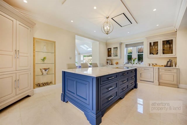 The hand painted kitchen is a fully fitted bespoke Kevin Roper designed room with central island
