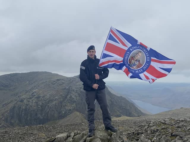 Royal Navy Leading hand Daniel Komocinski from Burnley plants the Union flag on top of Scafell Pike for King's Coronation