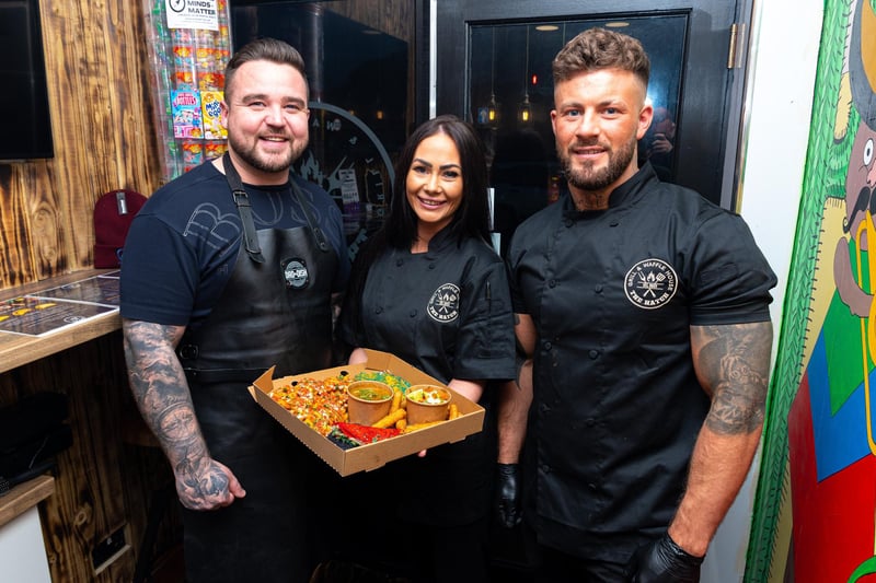 Simon Hannigan, better known as Dad The Dish, with Rachel Boys and Jonni Thomas, owners of what was then The Hatch Grill & Waffle House in Burnley, with the meal he prepared for sale in the takeaway. Photo: Kelvin Stuttard