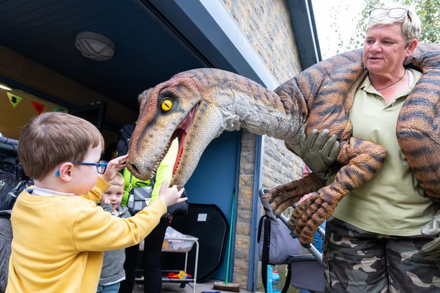 Riley (three) gets up close and personal with a dinosaur at the Tay Street Family Hub launch. Photo: Kelvin Lister-Stuttard