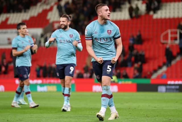 STOKE ON TRENT, ENGLAND - DECEMBER 30: Taylor Harwood-Bellis of Burnley celebrates following their sides victory after the Sky Bet Championship match between Stoke City and Burnley at Bet365 Stadium on December 30, 2022 in Stoke on Trent, England. (Photo by Charlotte Tattersall/Getty Images)
